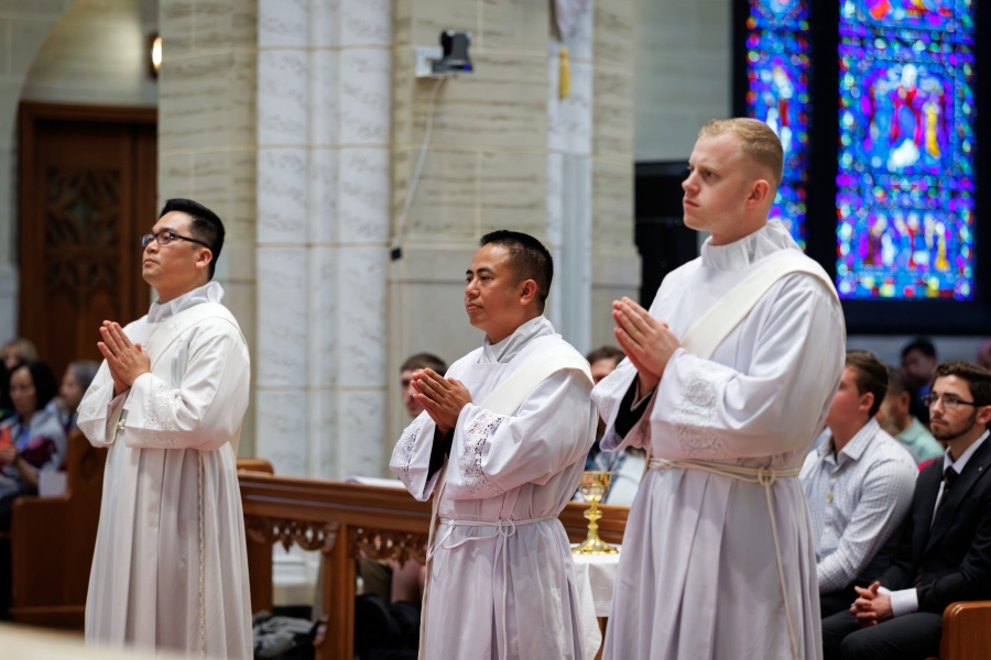 Three ordinands standing in a row