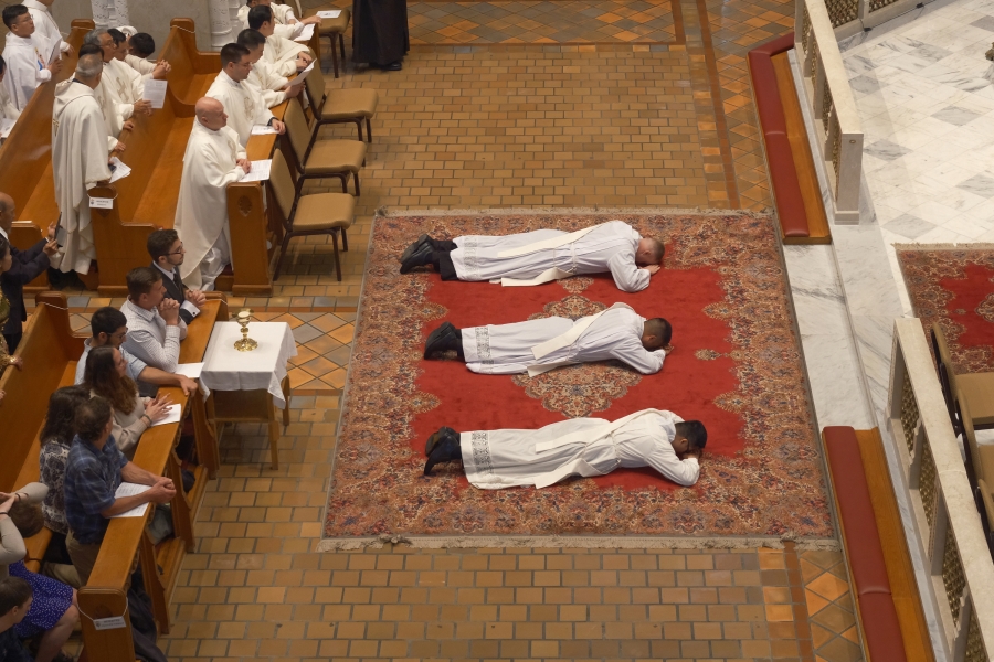 Three ordinands lie prostrate