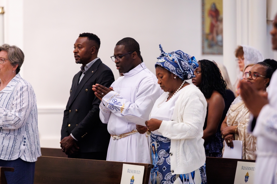 Evans Yongyee in the pew with friends.