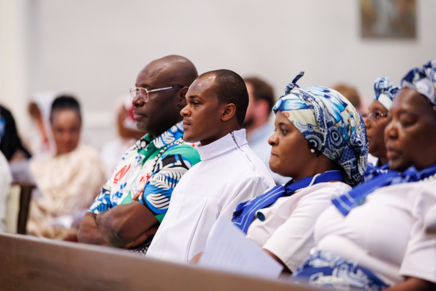 Ezekiel Banla in the pew with friends.