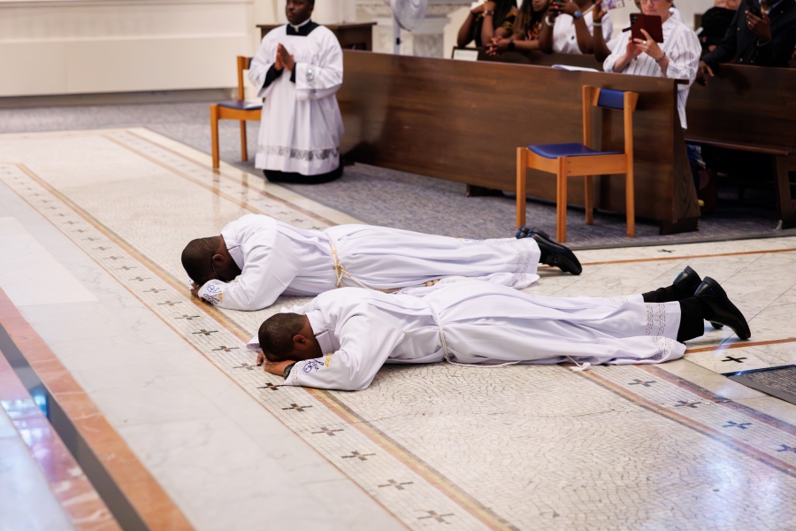 The ordinands prostrate themselves.