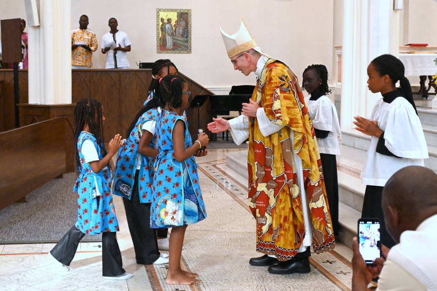Children bring the offertory gifts to the bishop.