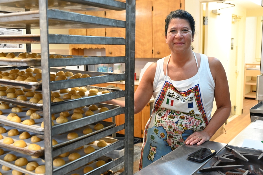 Becky Mitchell standing next to baking racks.