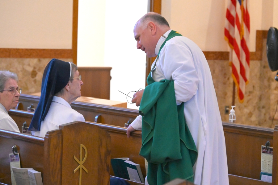 Father Daniel Greenleaf chats with Sister Marie May Lausier, PM