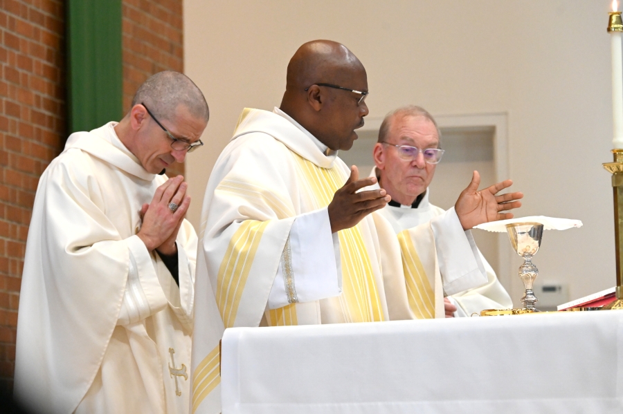 Father Patrick Agbodi reads the Eucharistic Prayer