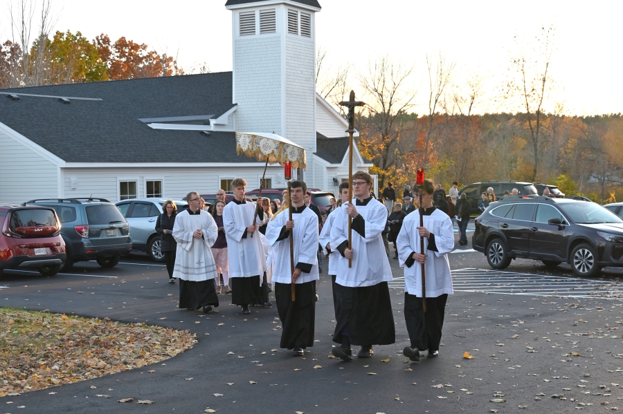 The eucharistic procession leaves Our Lady of Wisdom Church.