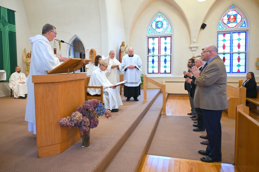 The deacon candidates stand before Bishop Ruggieri.