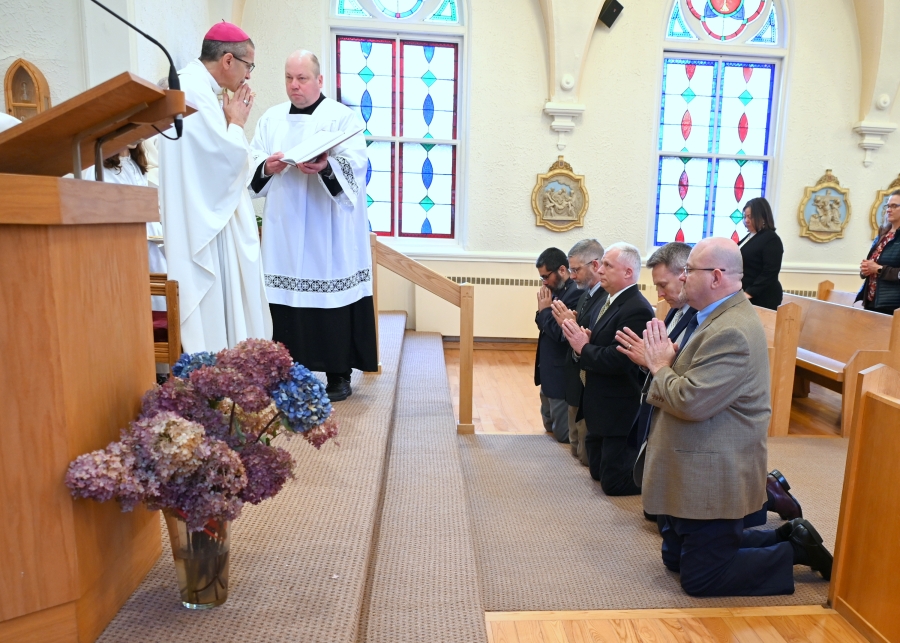 The deacon candidates kneel before Bishop Ruggieri.