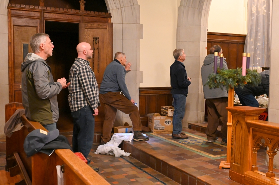 Knights of Columbus in a row viewing progress on the display.