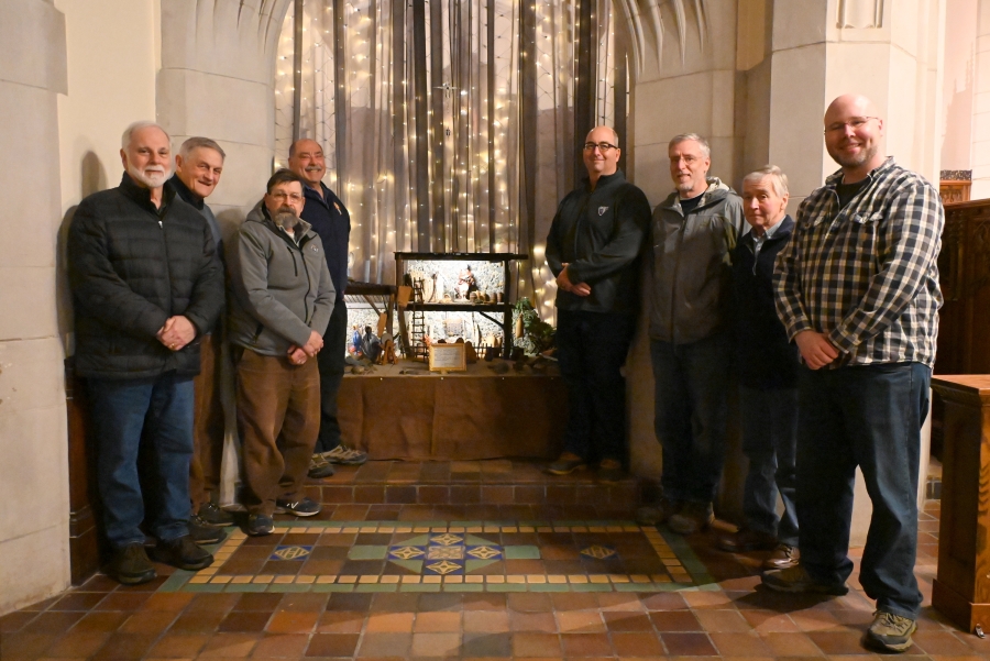 Knights of Columbus pose on either side of the manger.