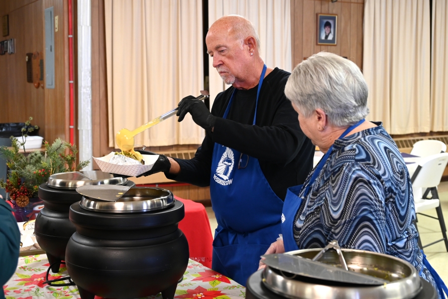 Volunteers serve at the community meal.