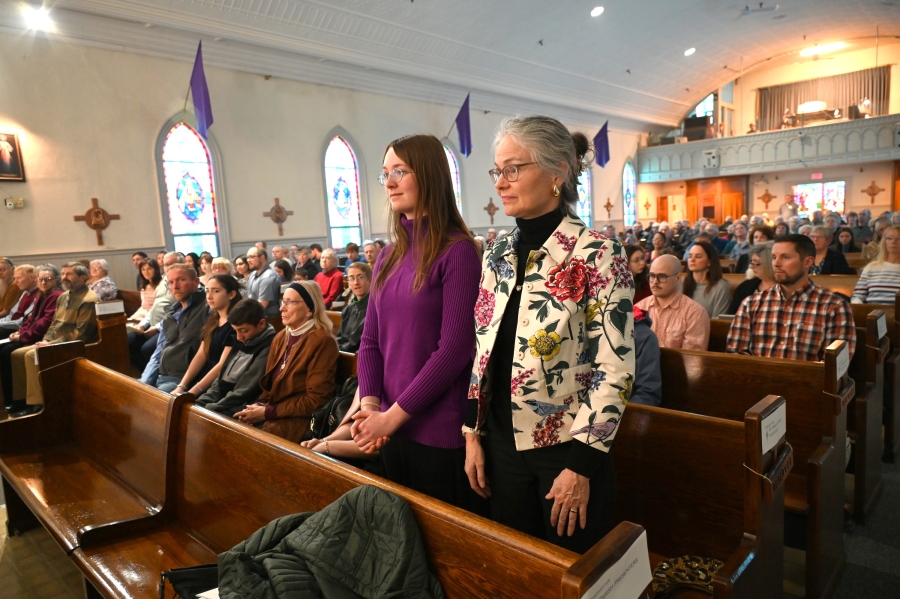 A woman stands with her sponsor.