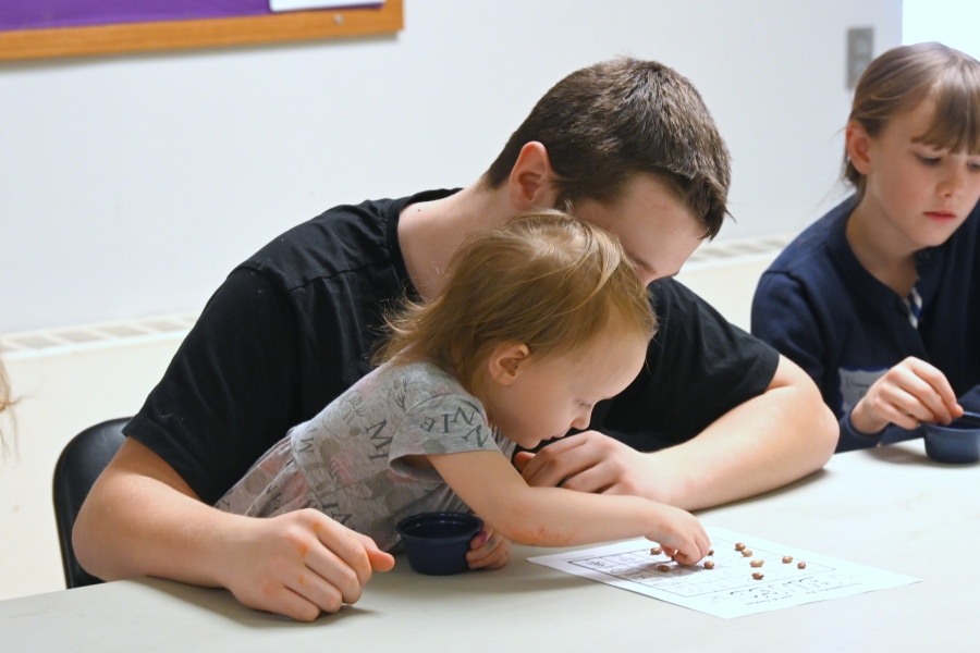 Boy and younger girl playing Bingo.