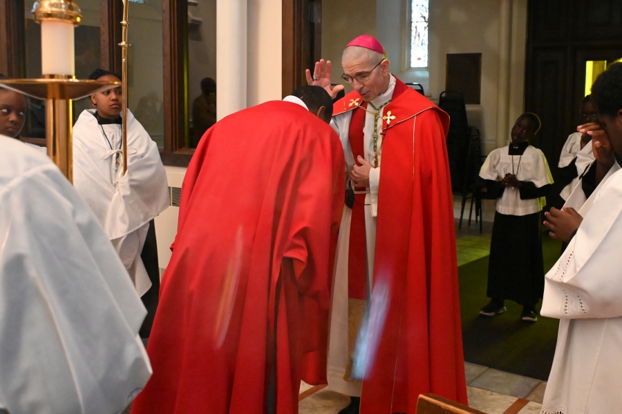 Bishop Ruggieri blesses Deacon Eskekiel Banla before he reads the Gospel.