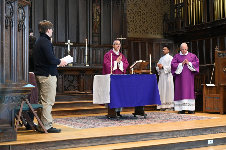 Bishop Ruggieri delivers the opening prayer while standing at the altar.