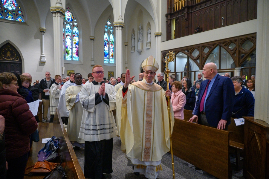 Priests exit after Mass