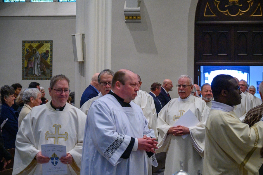 Priests enter Chrism Mass