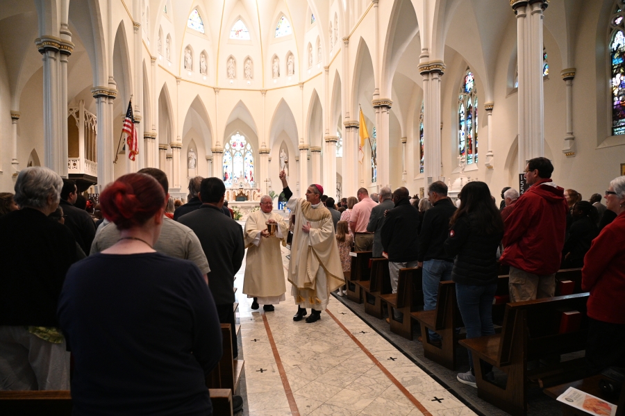 Bishop blessing the congregation with holy water