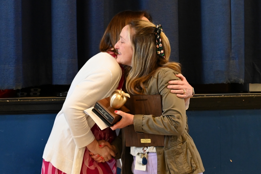 Christine Michaud receives a congratulatory hug from Shelly Wheeler.