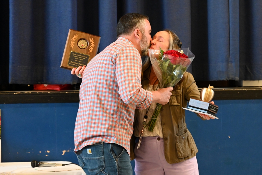 Christine Michaud receives a kiss from her husband.