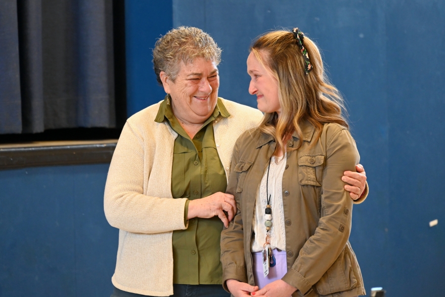 Christine Michaud receives congratulations from a fellow teacher.