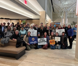 Group posed together in a hotel lobby