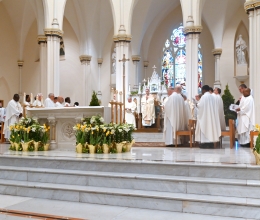 Bishop James Ruggieri and priests in the sanctuary of the cathedral