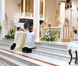 Father Brad Morin and two altar servers incensing the Blessed Sacrament.