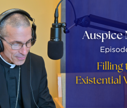 Bishop Ruggieri sitting in front of a microphone. text: "Auspice Maria, Episode 9 filling the existential vacuum"