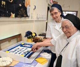 Sister Cecile Mondor and Sister Marie May Lausier cut a cake wishing them well.