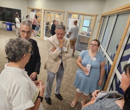 bishop speaking to a small group