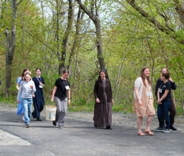 a group of young women walking with a Franciscan Sister 