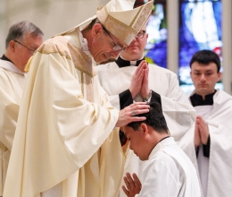 Bishop Ruggieri lays hands on Vinh Nguyen.