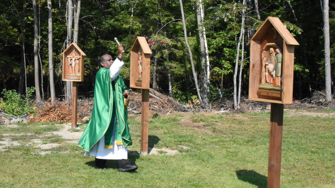 Father Dominic Savio blesses the Stations of the Cross.