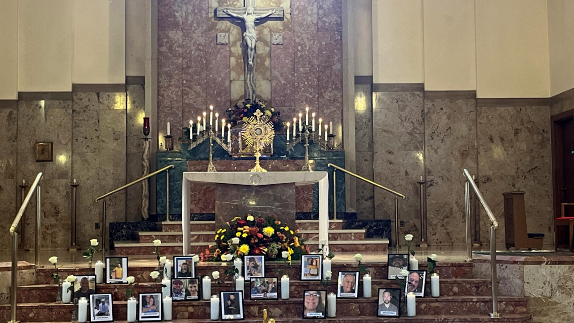 Holy Family Church with photos of shooting victims