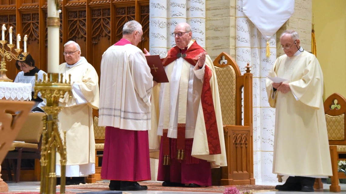 Bishop Deeley prays with Msgr. Marc Caron, Deacon Denis Mailhot, and Brother Irenee Richard, OP