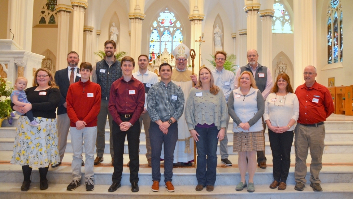 Neophytes pose with Bishop Deeley