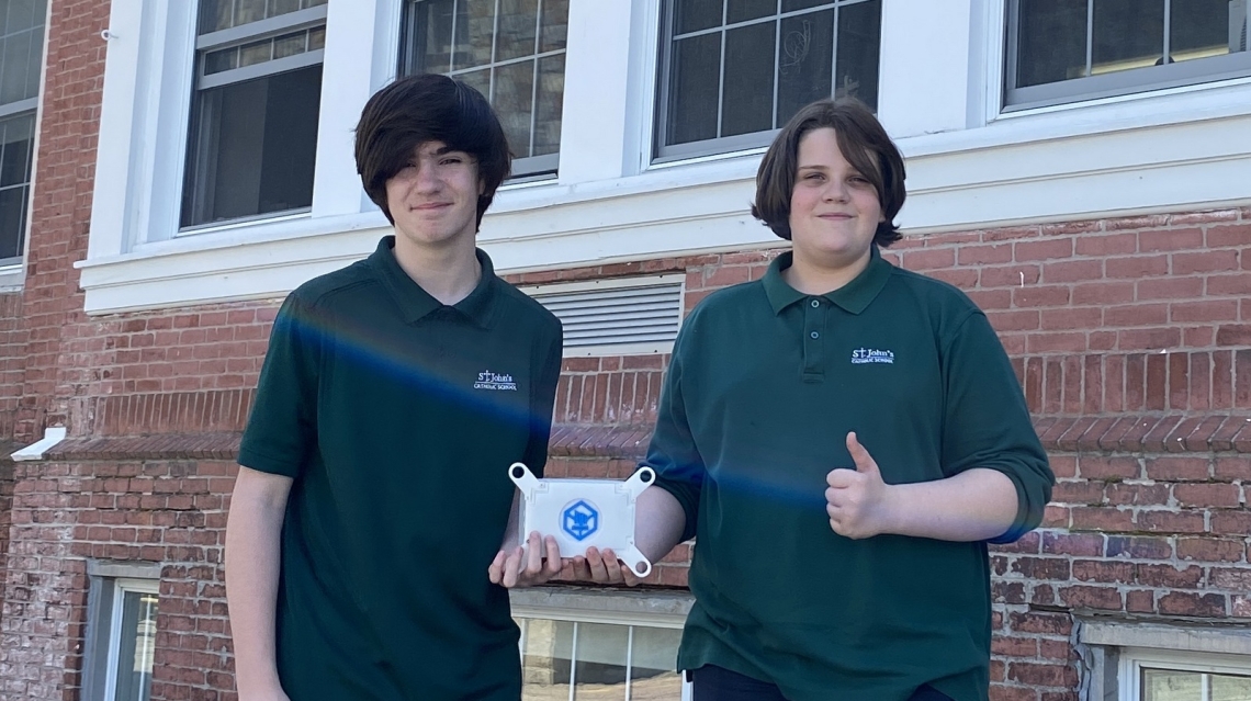 students holding small satellite 