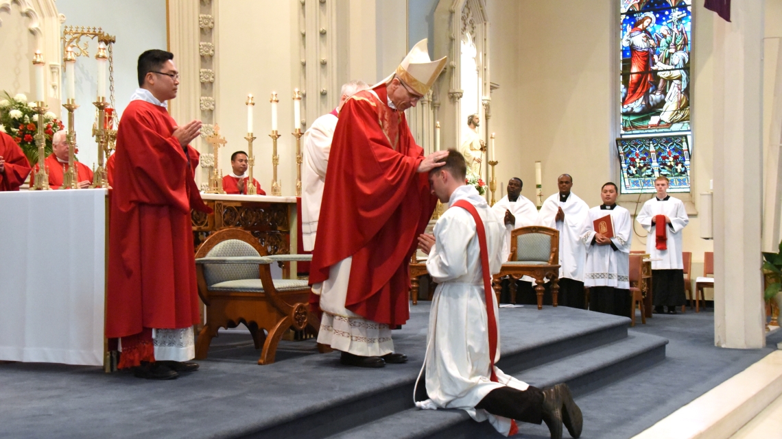 Bishop Ruggieri lays hands on Deacon Matthew Valles.