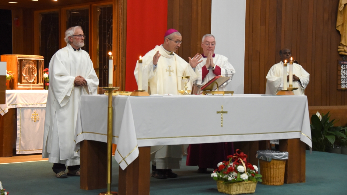Bishop James Ruggieri celebrates the Liturgy of the Eucharist. Deacon Danny Watson is on the bishop's right and Father Dominic Savio and Msgr. Marc Caron are on his left.