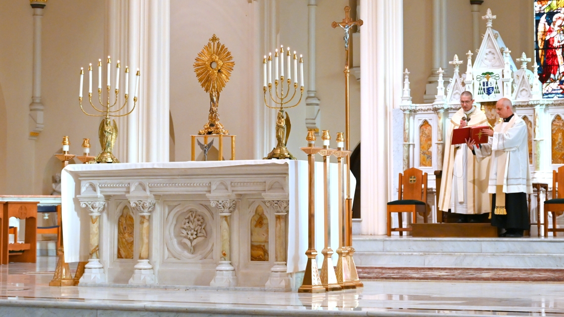 The Blessed Sacrament in the foreground with Bishop Ruggieri and Father Seamus Griesbach behind it.