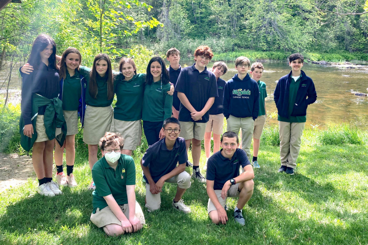 Seventh graders at the edge of Kenduskeag Stream