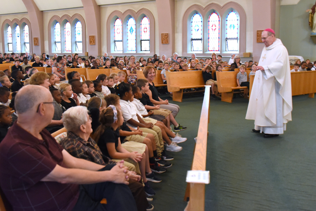 Bishop Deeley talks with students.