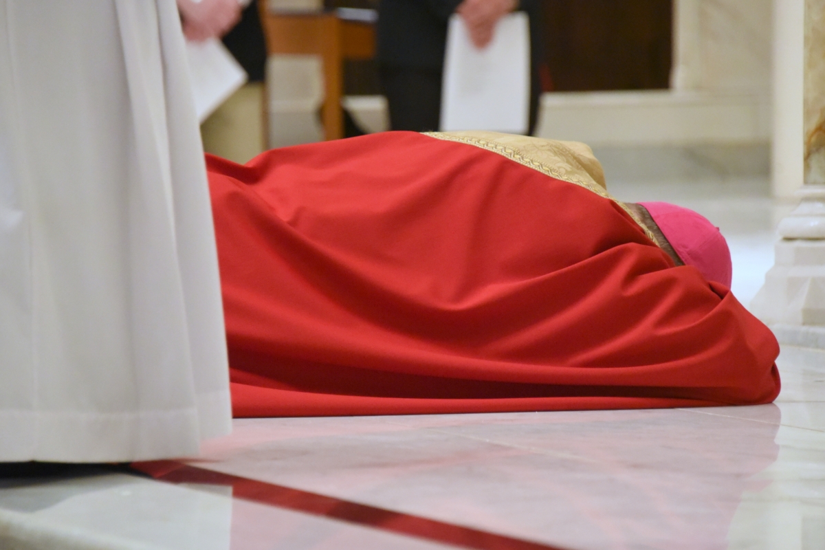 Bishop Deeley lying prostrate