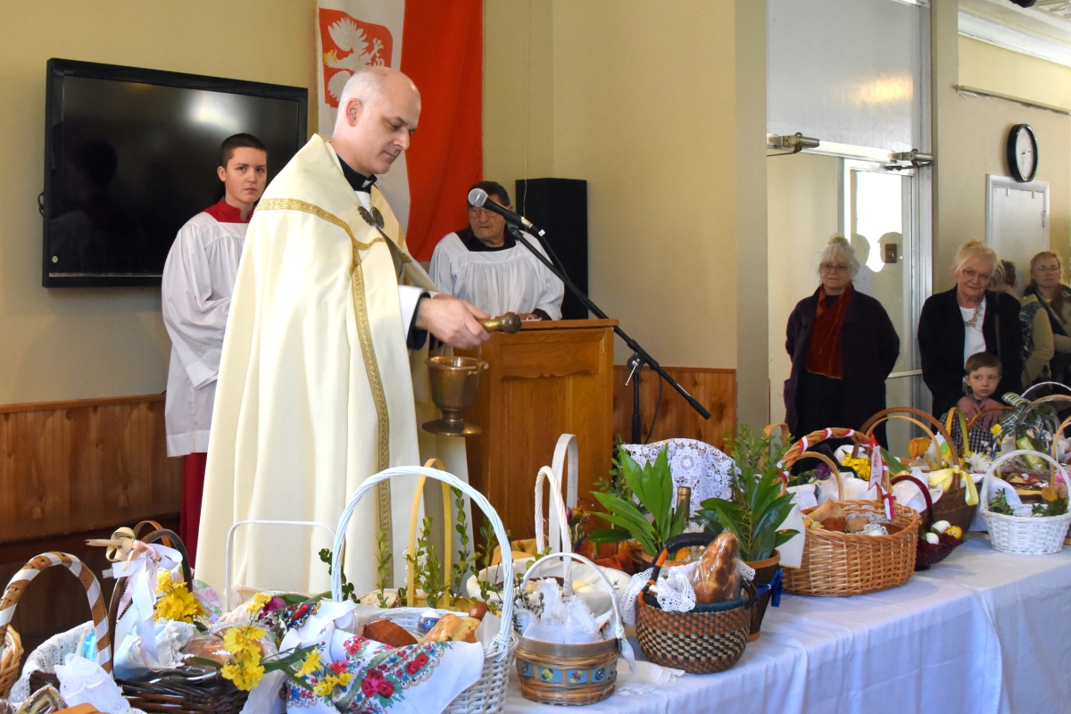 Father Seamus Griesbach blesses Easter baskets.