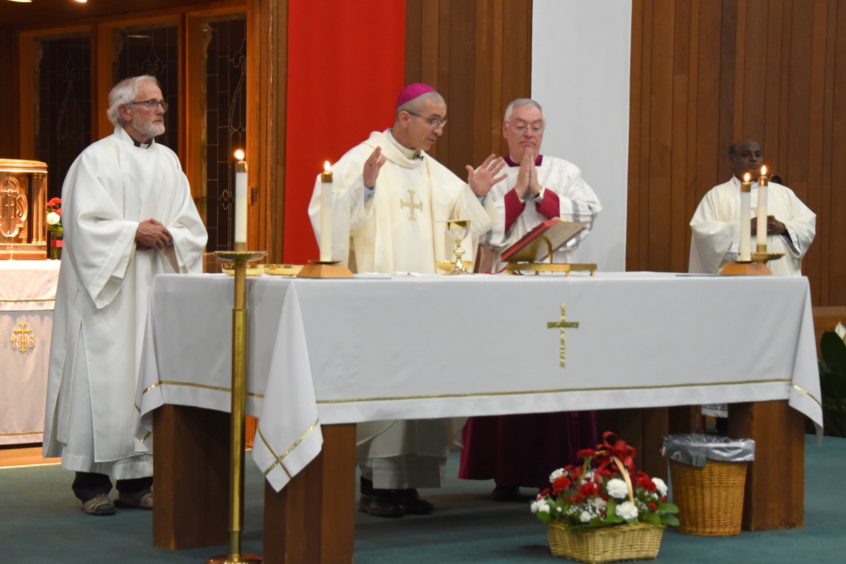 Bishop James Ruggieri celebrates the Liturgy of the Eucharist. Deacon Danny Watson is on the bishop's right and Father Dominic Savio and Msgr. Marc Caron are on his left.
