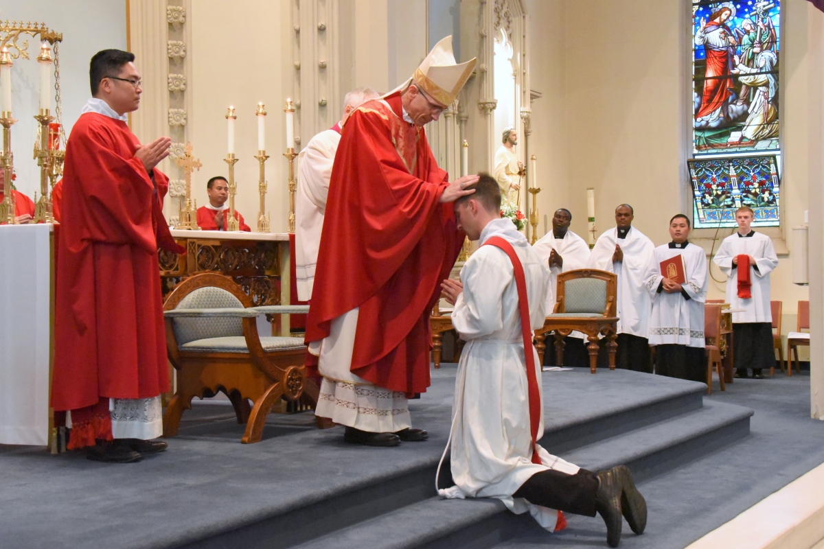 Bishop James Ruggieri lays hands on Deacon Matthew Valles