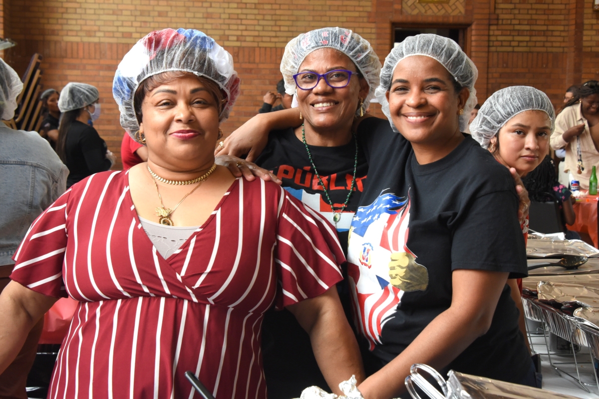 Three women volunteers serving food.