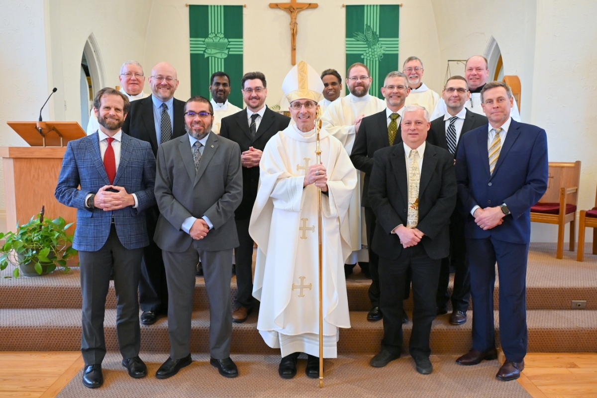 Eight deacon candidates with Bishop James Ruggieri, three priests, two deacons, and Peter Czerwinski.