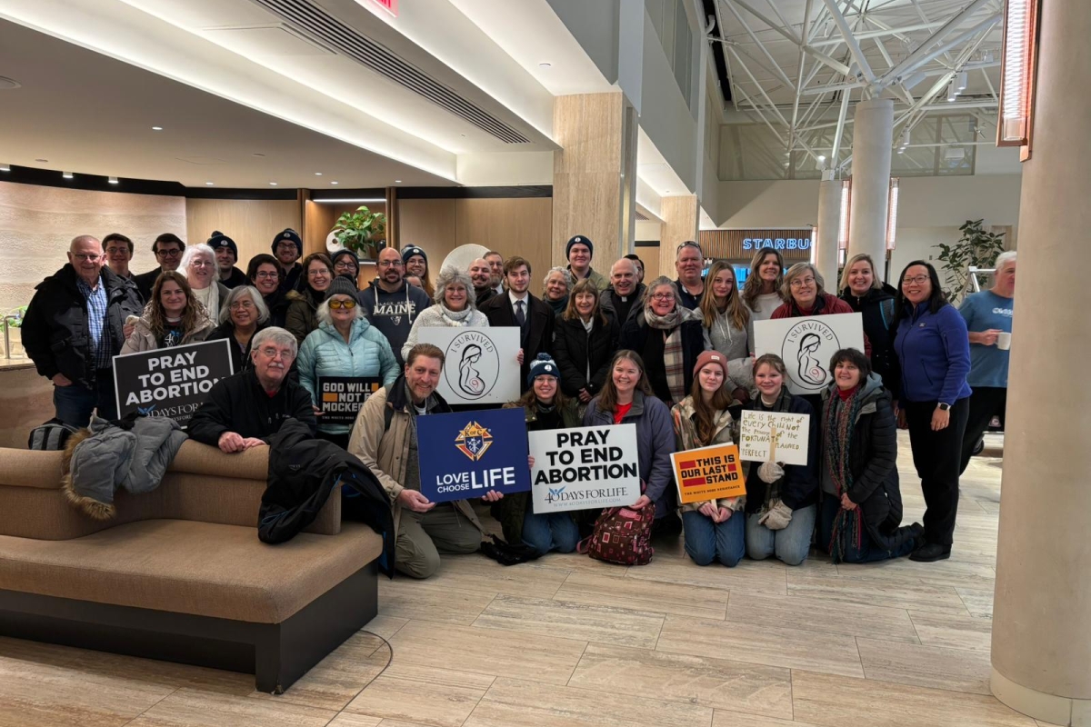 Group posed together in a hotel lobby